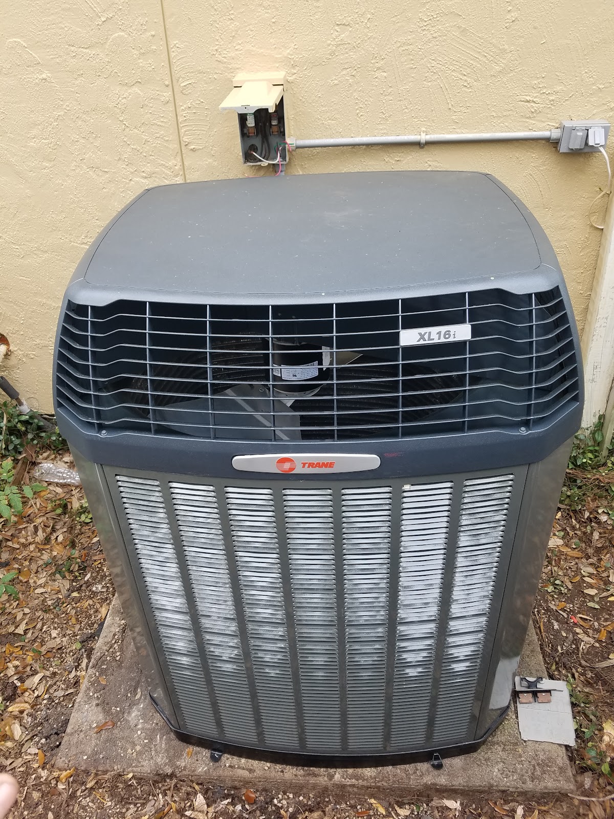 A clean Trane XL16i outdoor unit installed by All Seasons