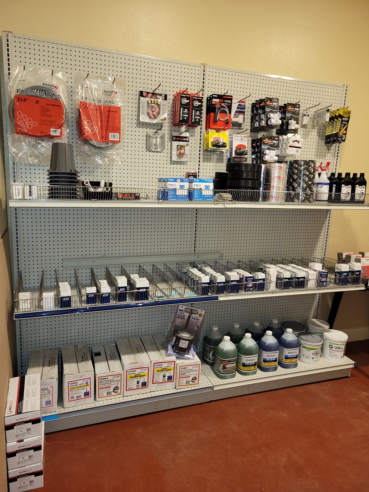 Well stocked HVAC parts and supplies shelf in the All Seasons shop