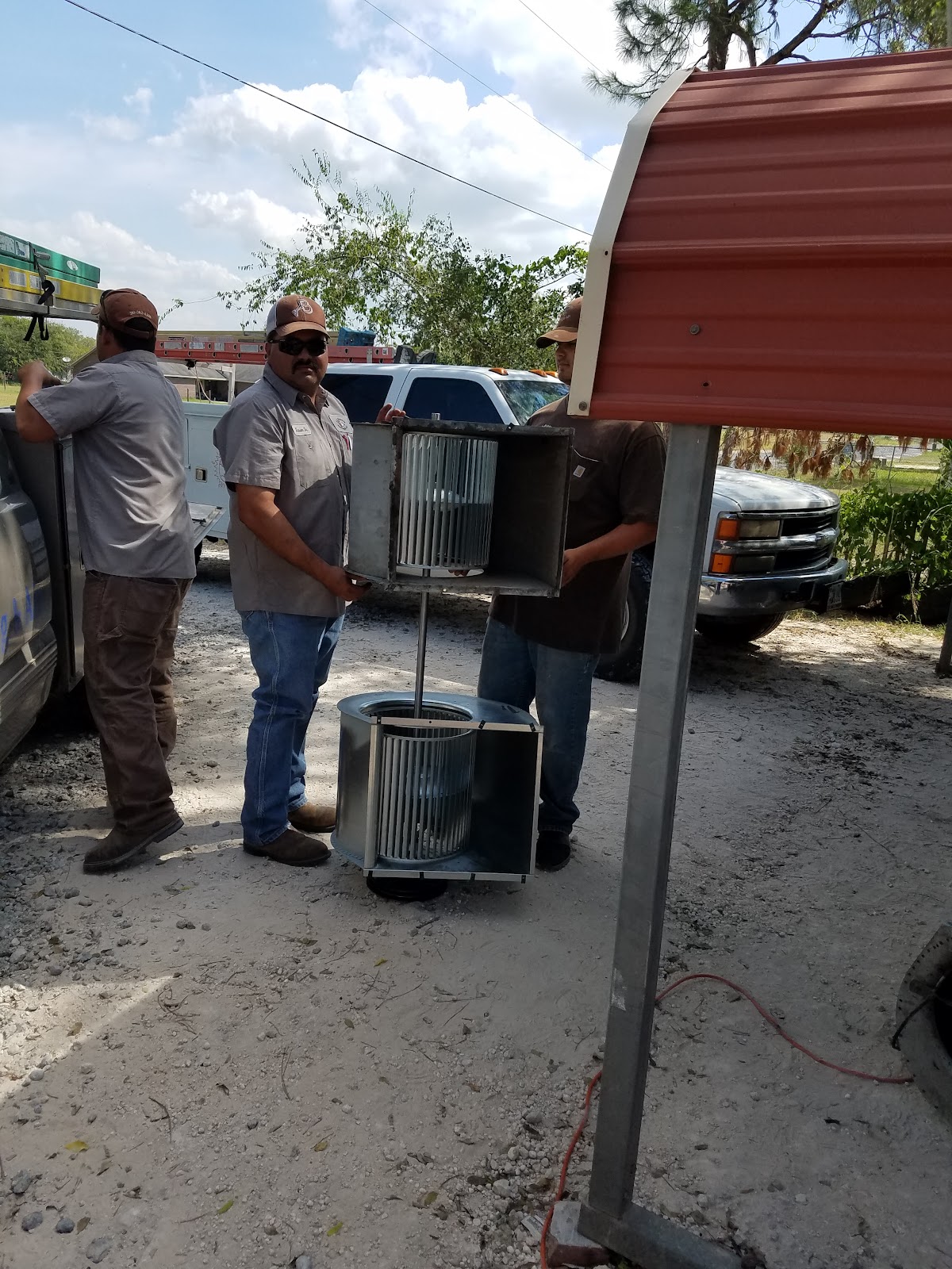 The All Seasons crew handling a blower assembly