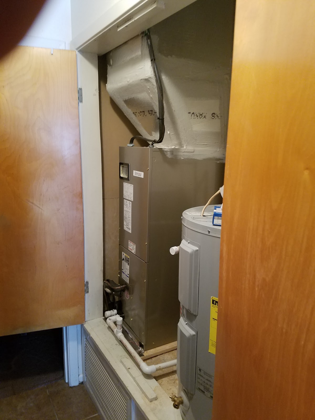 Air handler and furnace unit installed in a utility closet