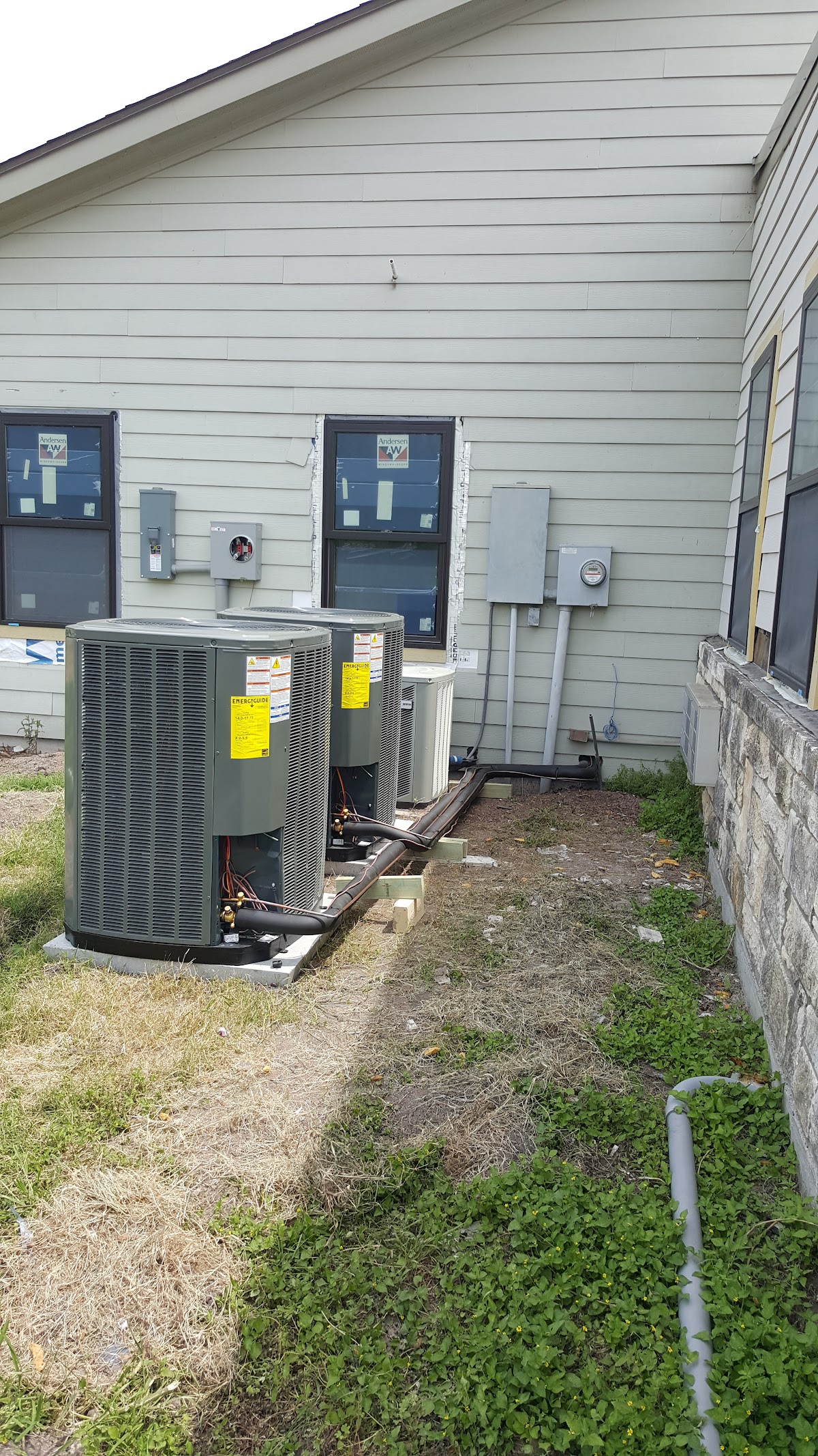 Multiple outdoor AC units installed side by side on a commercial building